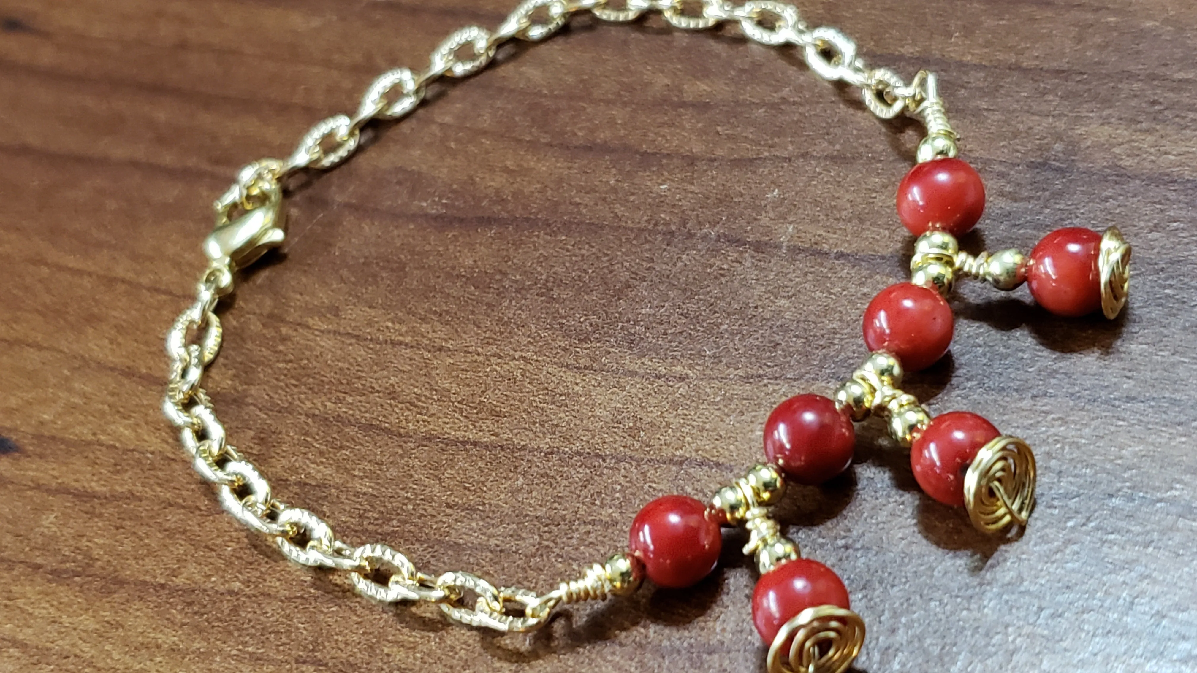 Red Coral Rounds with Gold Tone Chain & Wire Bracelet. Adjustable to 7" with Lobster Claw Clasp