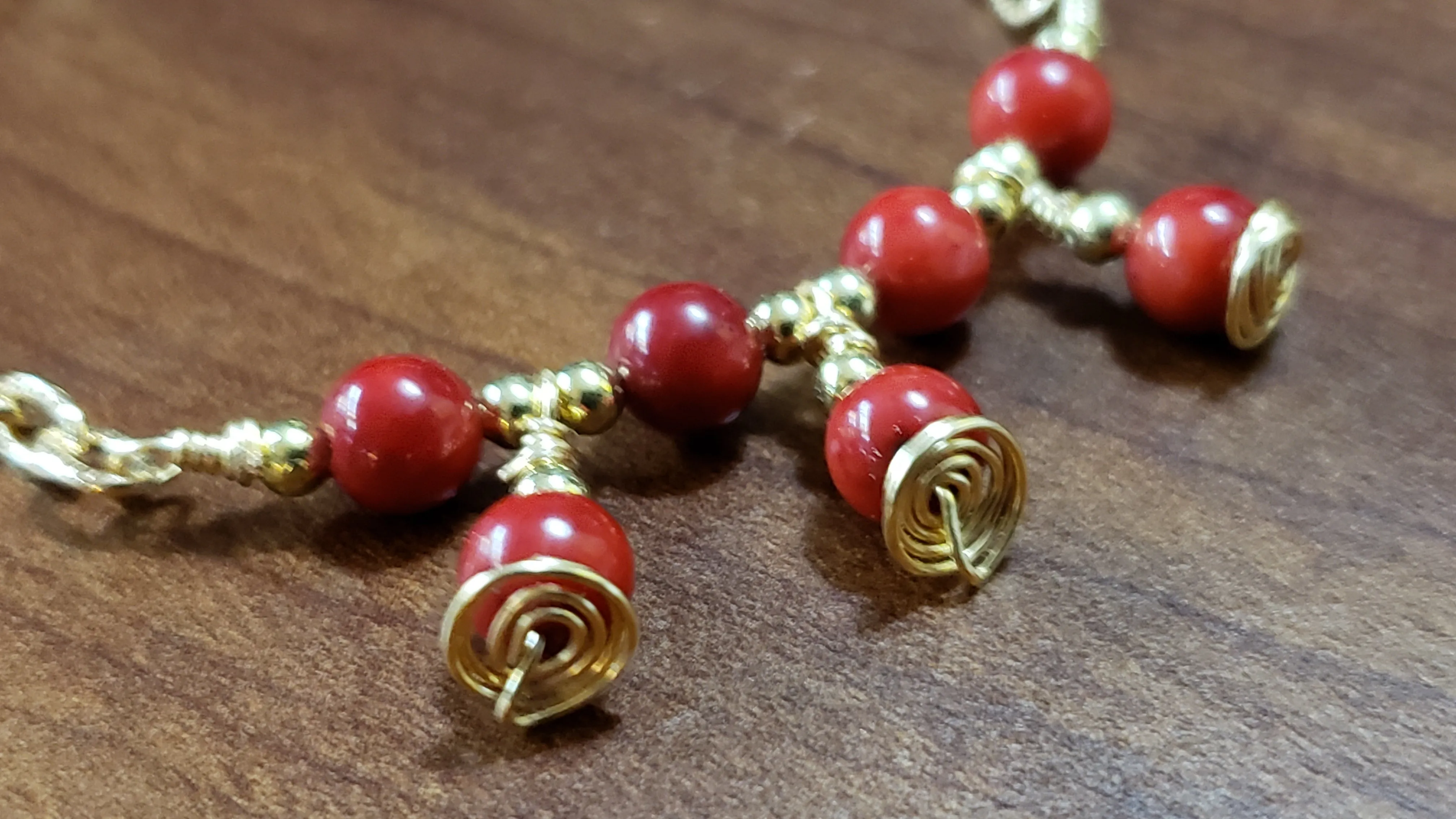 Red Coral Rounds with Gold Tone Chain & Wire Bracelet. Adjustable to 7" with Lobster Claw Clasp