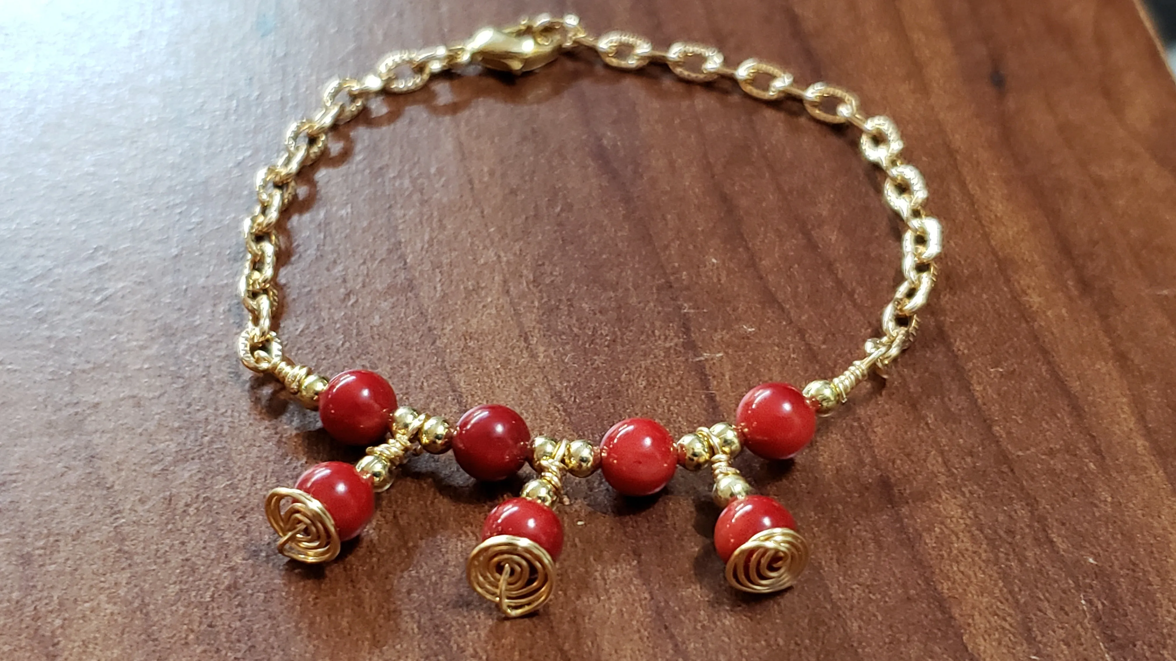 Red Coral Rounds with Gold Tone Chain & Wire Bracelet. Adjustable to 7" with Lobster Claw Clasp